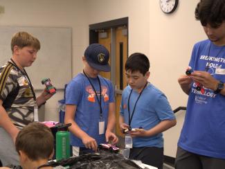 Campers working on racing cars