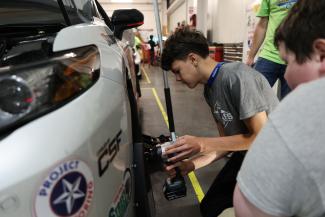 Camper working on car wheel