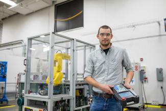 Student holding robot controller